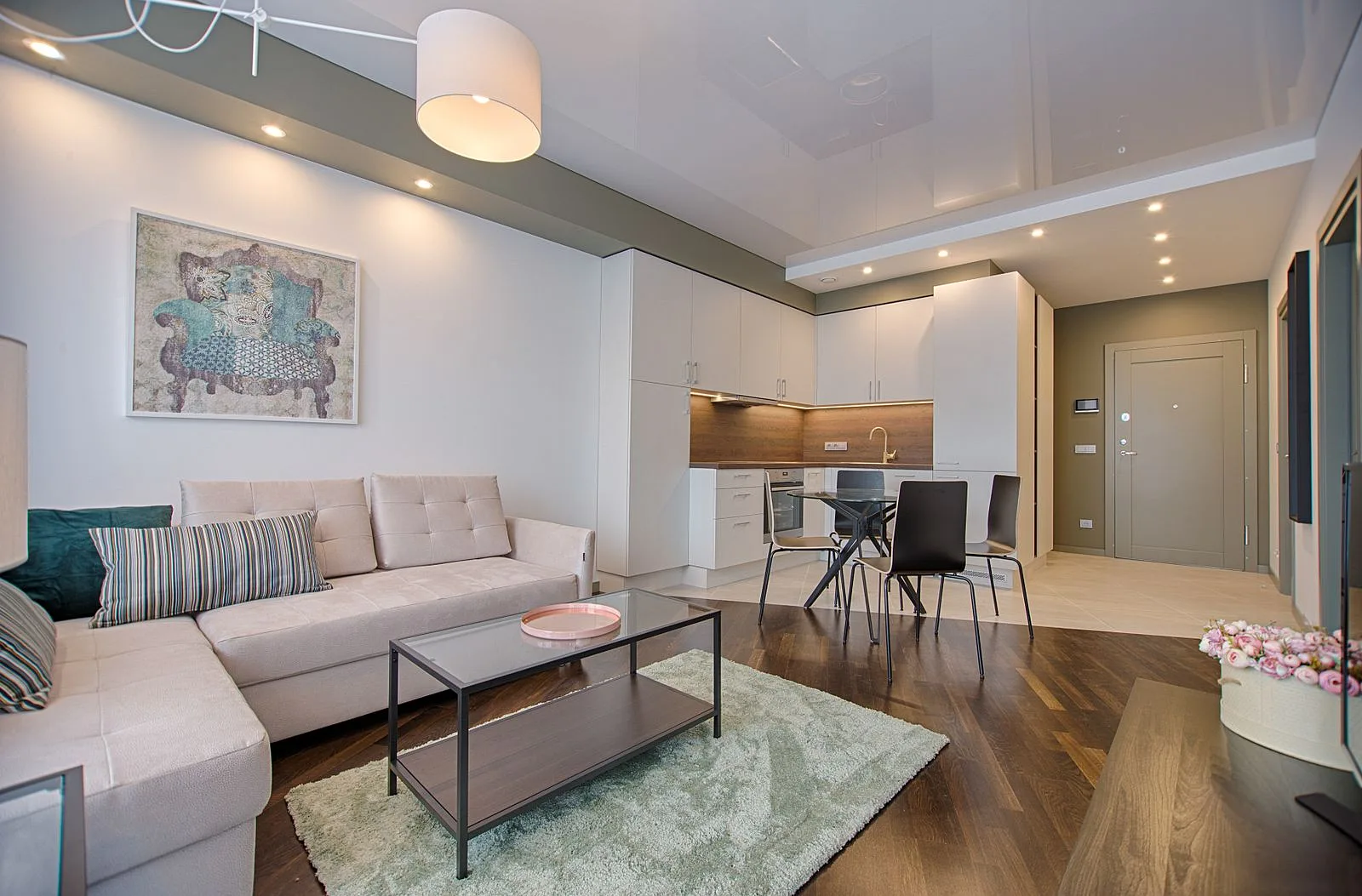 Modern open-plan living space with composed furnishings and a quiet palette